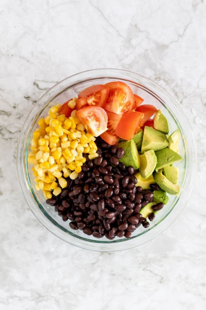 top down view showing avocado, tomato, corn, and black beans